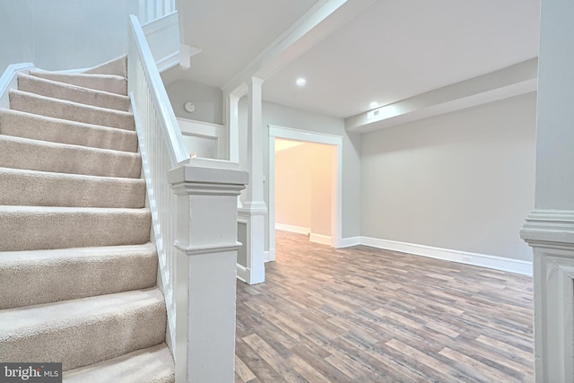 stairs featuring recessed lighting, baseboards, and wood finished floors