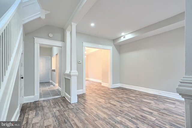 interior space with visible vents, stairway, wood finished floors, and baseboards