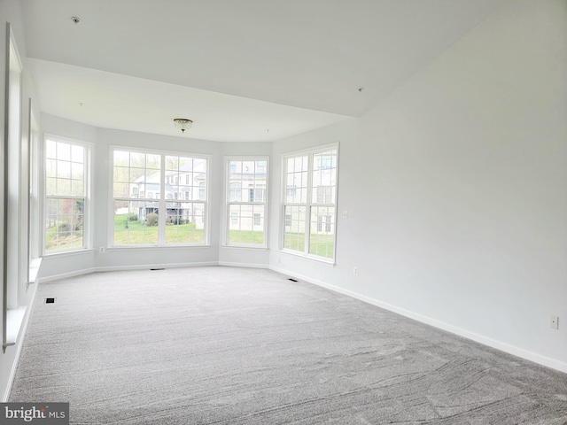 carpeted spare room with baseboards