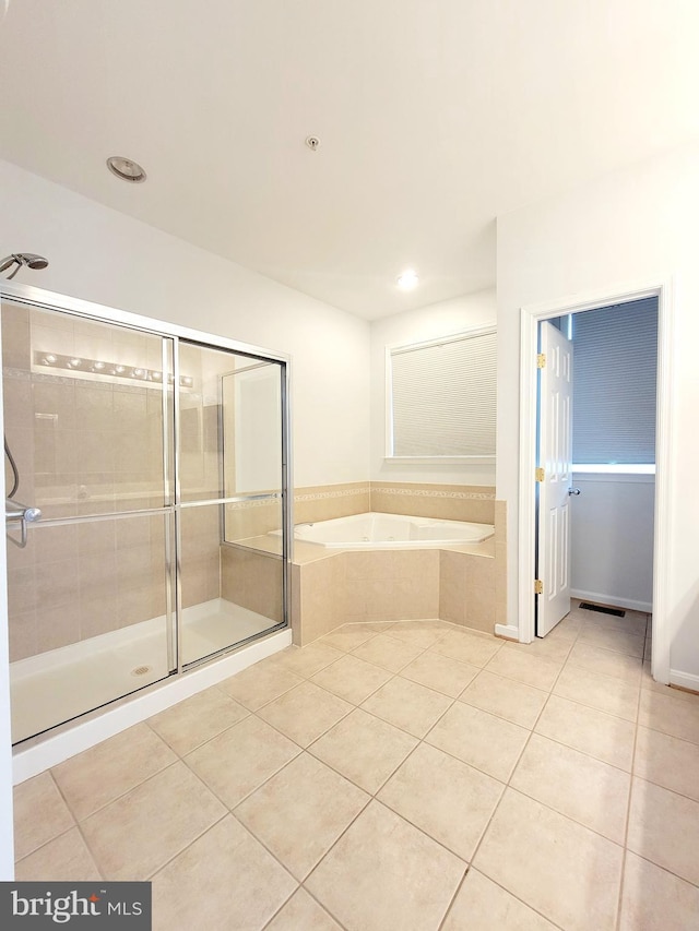 full bathroom featuring tile patterned floors, visible vents, a stall shower, and a bath