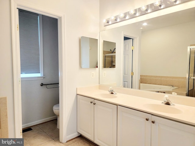 full bath with a garden tub, double vanity, a sink, and tile patterned floors