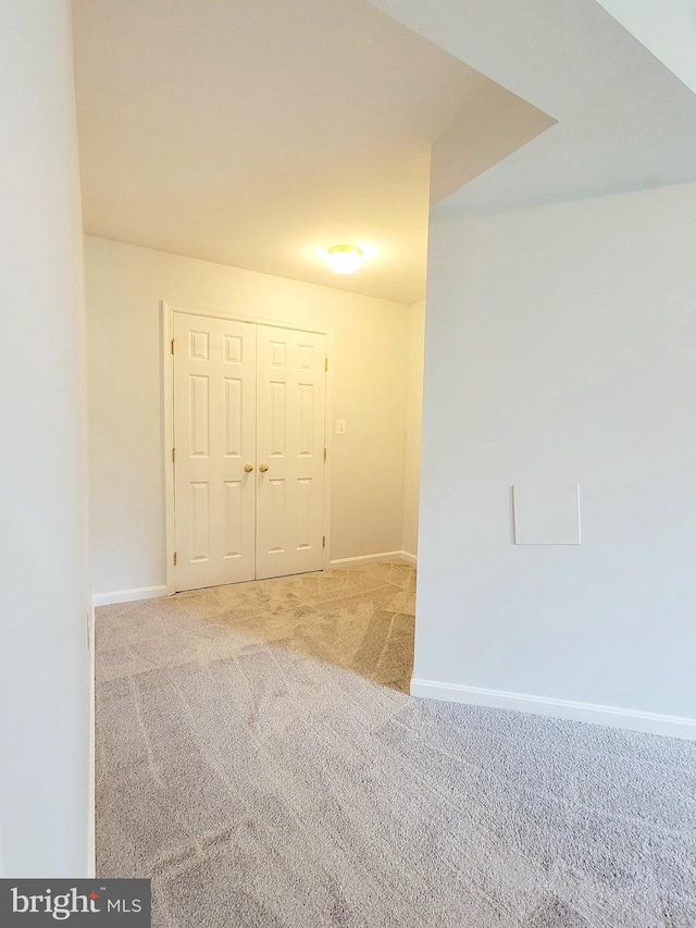 carpeted spare room with baseboards