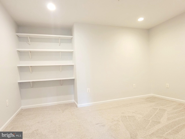 unfurnished room featuring baseboards, recessed lighting, and light carpet