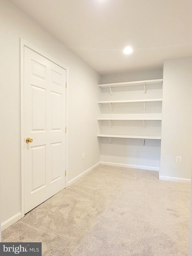 interior space featuring light carpet, baseboards, and recessed lighting