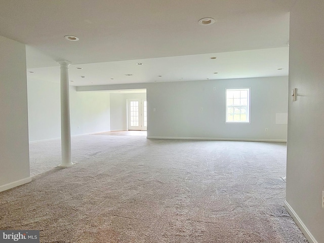 carpeted spare room with baseboards, recessed lighting, and decorative columns