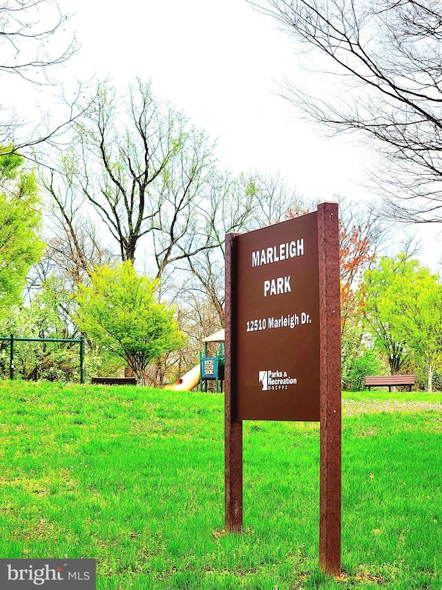community / neighborhood sign with a yard