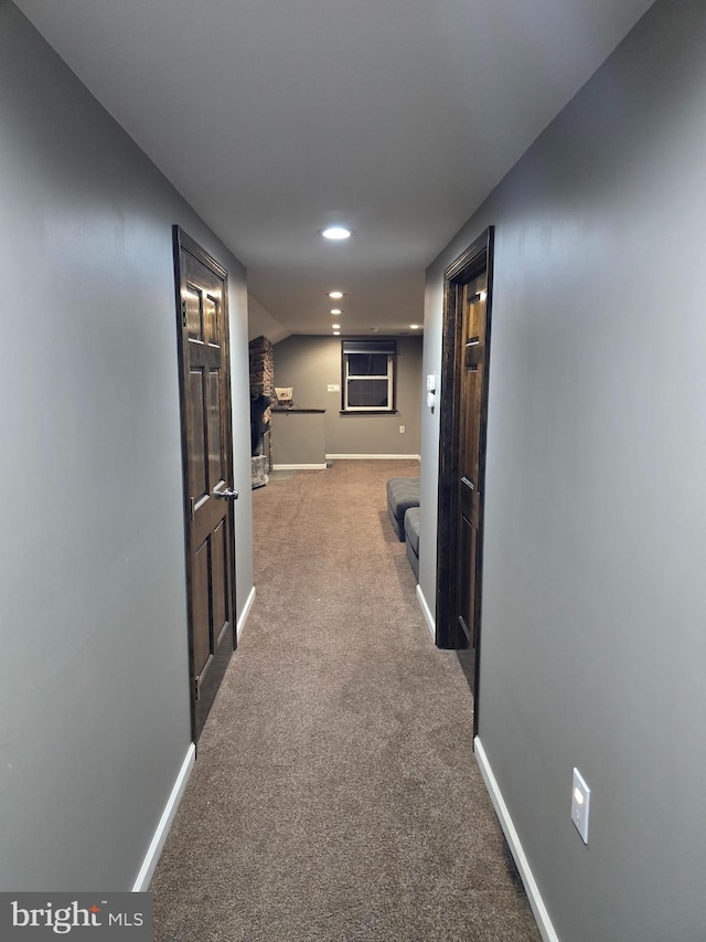 corridor featuring recessed lighting, carpet, and baseboards