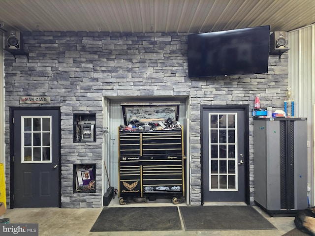 doorway to property featuring stone siding