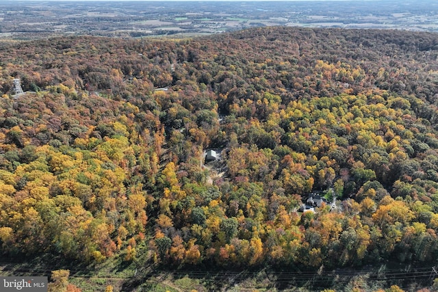 drone / aerial view featuring a forest view