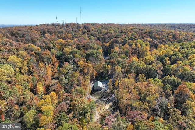 birds eye view of property with a view of trees