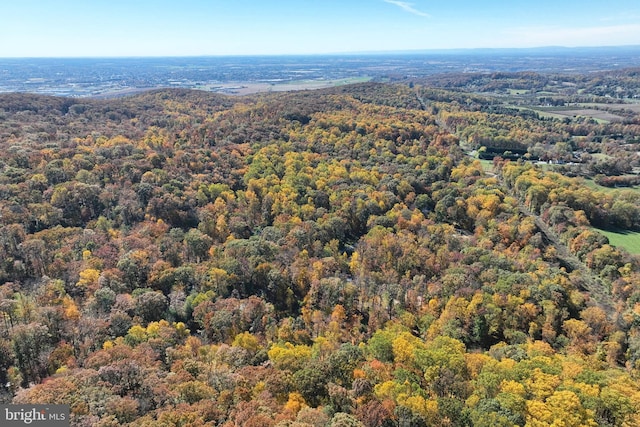 aerial view featuring a wooded view