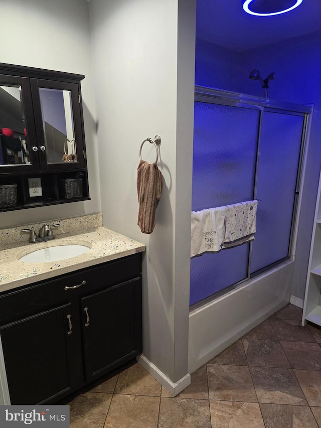 bathroom featuring shower / bath combination, baseboards, vanity, and tile patterned flooring