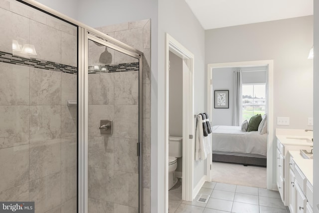 ensuite bathroom with tile patterned floors, toilet, a stall shower, ensuite bath, and vanity