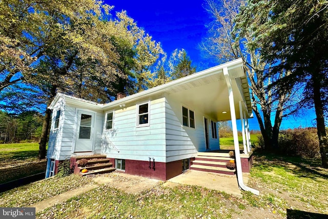18928 National Pike, Frostburg, MD 21532 - view of front of house featuring entry steps, a carport, a porch, and a chimney