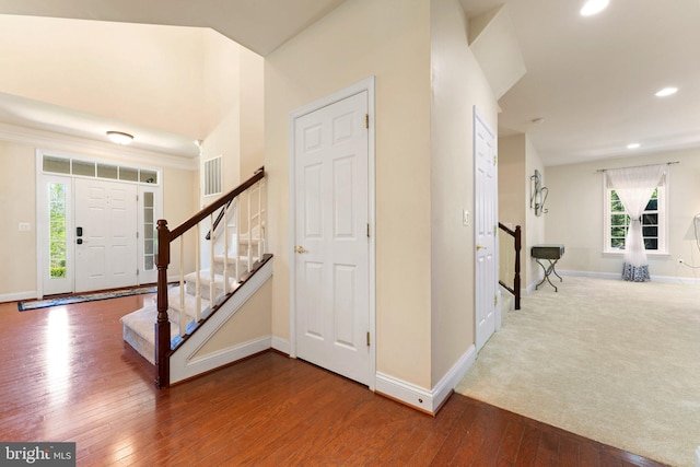 foyer with visible vents, hardwood / wood-style flooring, and baseboards