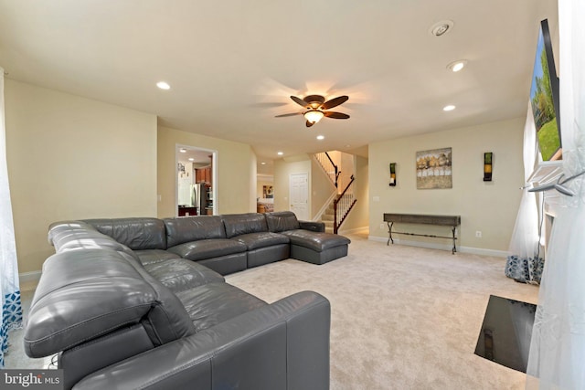 carpeted living room featuring recessed lighting, ceiling fan, stairway, and baseboards