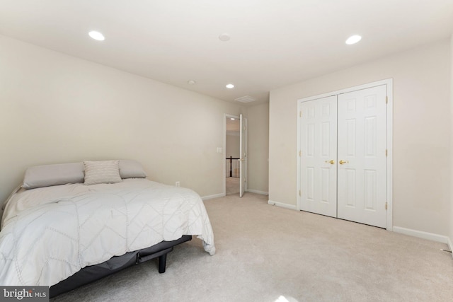 bedroom with light colored carpet, recessed lighting, and baseboards