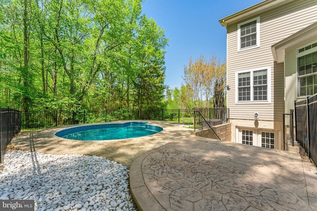 view of swimming pool featuring a patio, a fenced in pool, and a fenced backyard