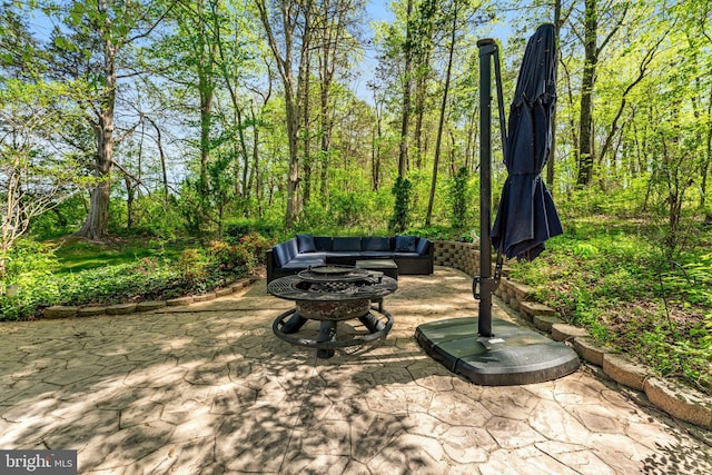 view of patio featuring an outdoor living space with a fire pit