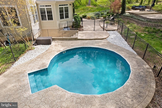 view of swimming pool featuring fence, a patio, and a fenced in pool