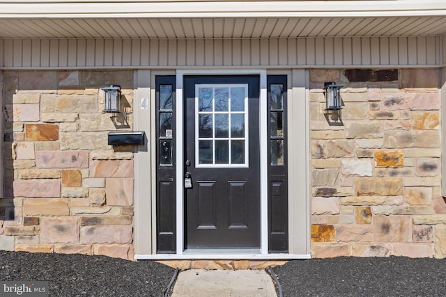 entrance to property with stone siding
