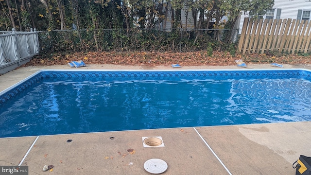 view of pool with a fenced in pool and fence