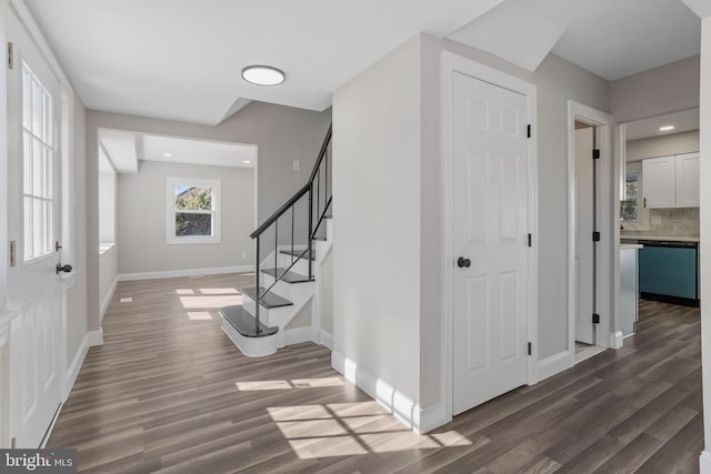 foyer with recessed lighting, stairway, baseboards, and dark wood-type flooring