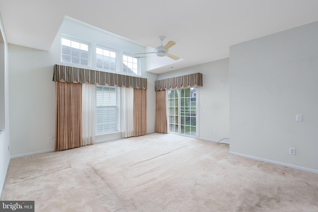 unfurnished room with baseboards, a ceiling fan, and carpet flooring