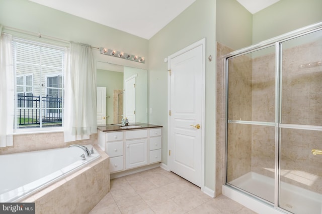 bathroom featuring tile patterned flooring, a garden tub, vanity, and a stall shower