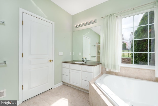 bathroom featuring a bath, vanity, tile patterned flooring, and visible vents