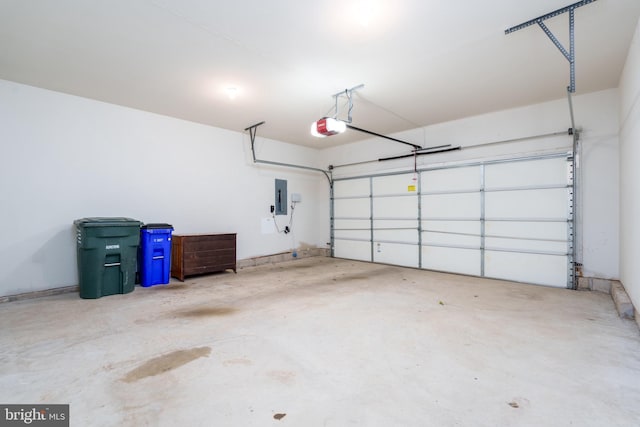 garage with electric panel and a garage door opener