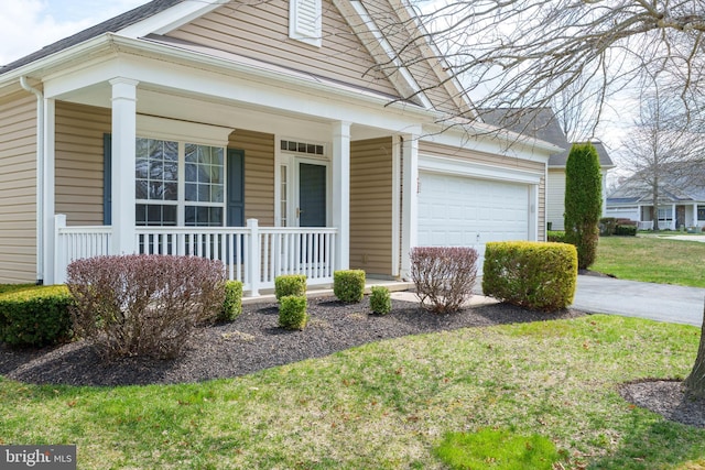 view of front of house featuring driveway, covered porch, a front yard, and a garage