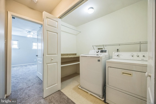washroom featuring laundry area, ceiling fan, light colored carpet, and washing machine and clothes dryer