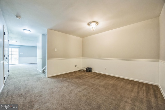 carpeted spare room with baseboards