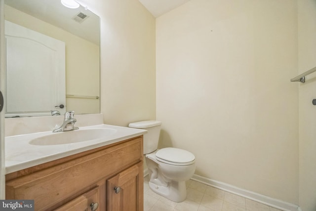 bathroom with visible vents, vanity, toilet, baseboards, and tile patterned floors