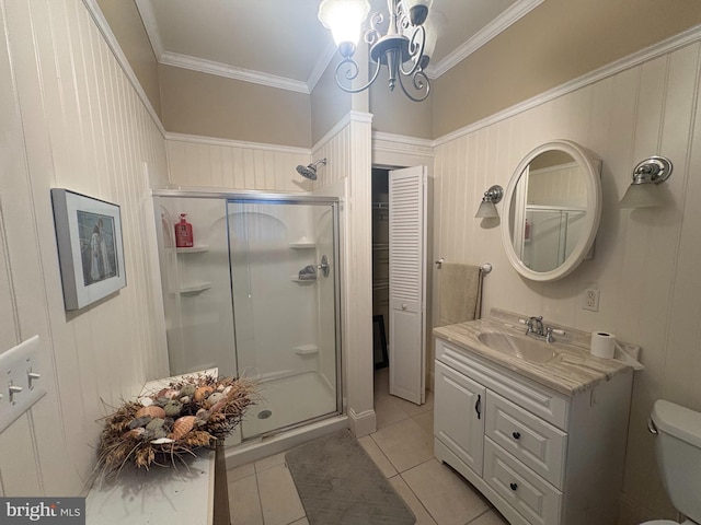 bathroom featuring a notable chandelier, a stall shower, vanity, and ornamental molding