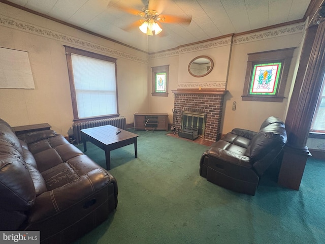 living room featuring radiator, a ceiling fan, carpet, and a brick fireplace