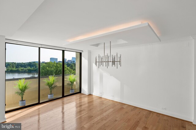 2700 Virginia Ave NW Unit 811, Washington, DC 20037 - unfurnished room featuring a wall of windows, wood finished floors, and a water view