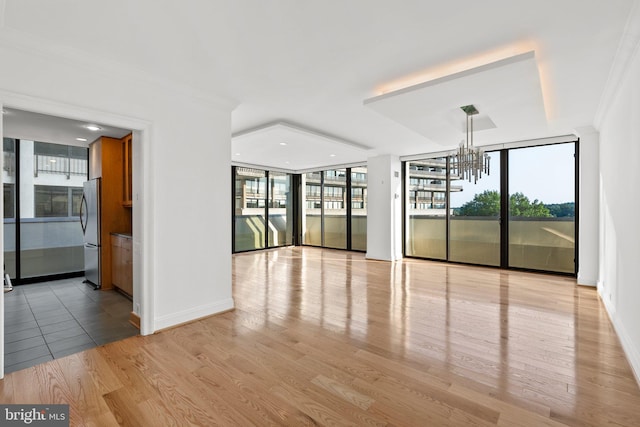 2700 Virginia Ave NW Unit 811, Washington, DC 20037 - spare room featuring a chandelier, wood finished floors, crown molding, expansive windows, and recessed lighting