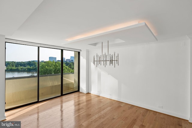 2700 Virginia Ave NW Unit 811, Washington, DC 20037 - unfurnished room with wood finished floors, floor to ceiling windows, and a water view