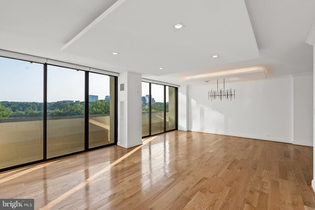 2700 Virginia Ave NW Unit 811, Washington, DC 20037 - unfurnished room featuring floor to ceiling windows, a chandelier, wood finished floors, and recessed lighting