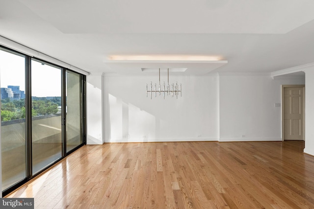 2700 Virginia Ave NW Unit 811, Washington, DC 20037 - spare room featuring light wood-type flooring, a wall of windows, ornamental molding, and a chandelier