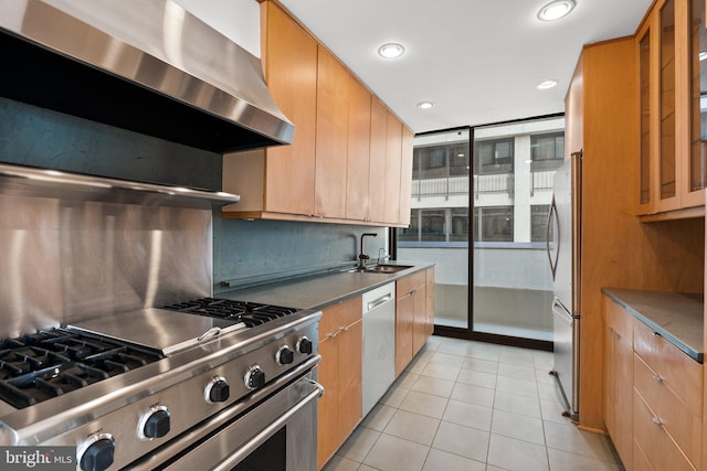 2700 Virginia Ave NW Unit 811, Washington, DC 20037 - kitchen featuring appliances with stainless steel finishes, wall chimney exhaust hood, tasteful backsplash, light tile patterned flooring, and recessed lighting