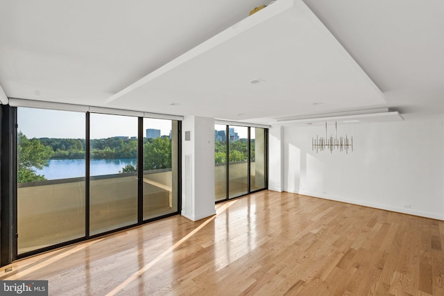 2700 Virginia Ave NW Unit 811, Washington, DC 20037 - empty room with floor to ceiling windows, wood finished floors, and a water view