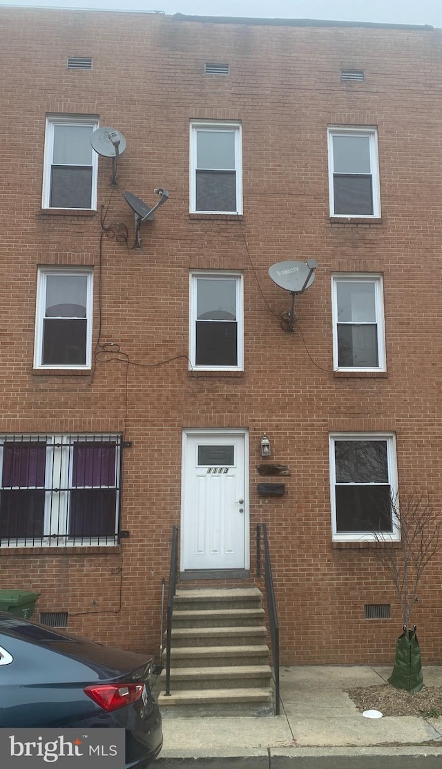 view of front of house with brick siding and entry steps