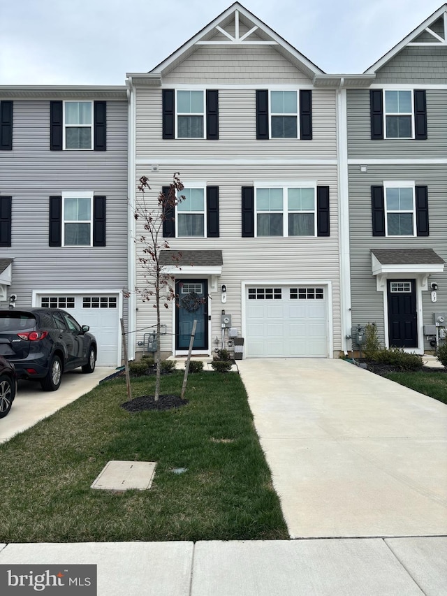 9 Riley St, Williamstown, NJ 08094 - townhome / multi-family property with a front yard, concrete driveway, and a garage