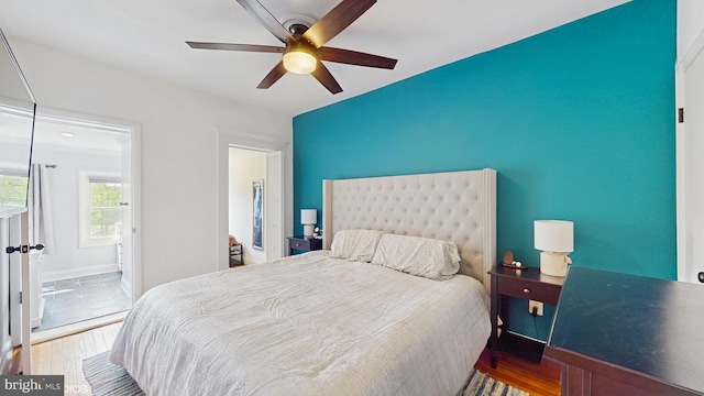bedroom featuring baseboards, ceiling fan, and wood finished floors