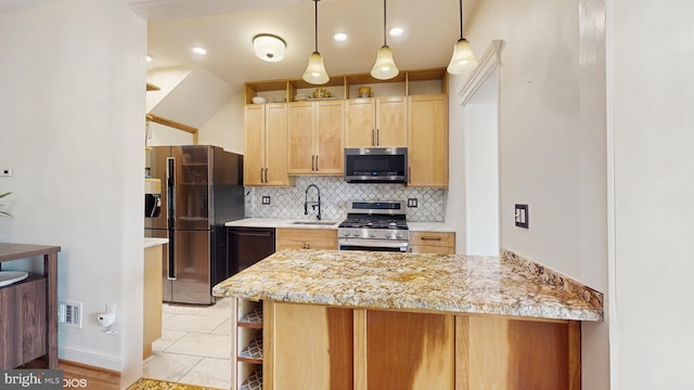 kitchen featuring a peninsula, light brown cabinetry, tasteful backsplash, a sink, and stainless steel appliances