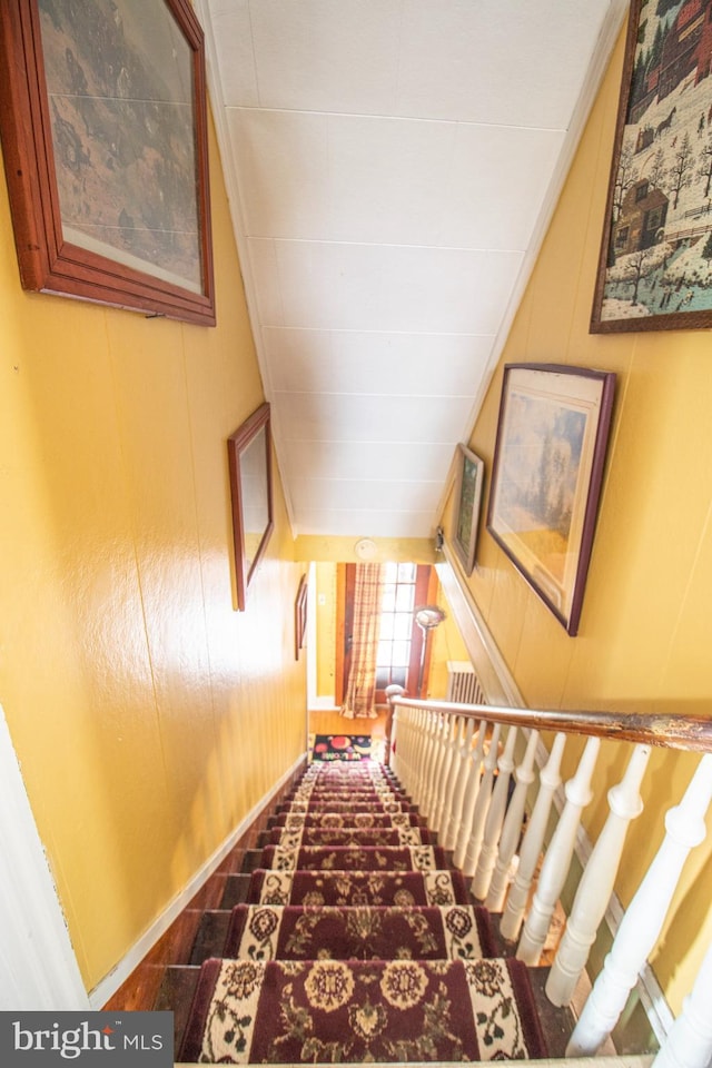 606 Ridgley St, Orbisonia, PA 17243 - staircase featuring baseboards, wooden walls, and lofted ceiling