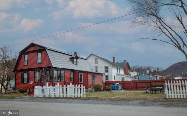 606 Ridgley St, Orbisonia, PA 17243 - dutch colonial featuring a gambrel roof, metal roof, and a fenced front yard